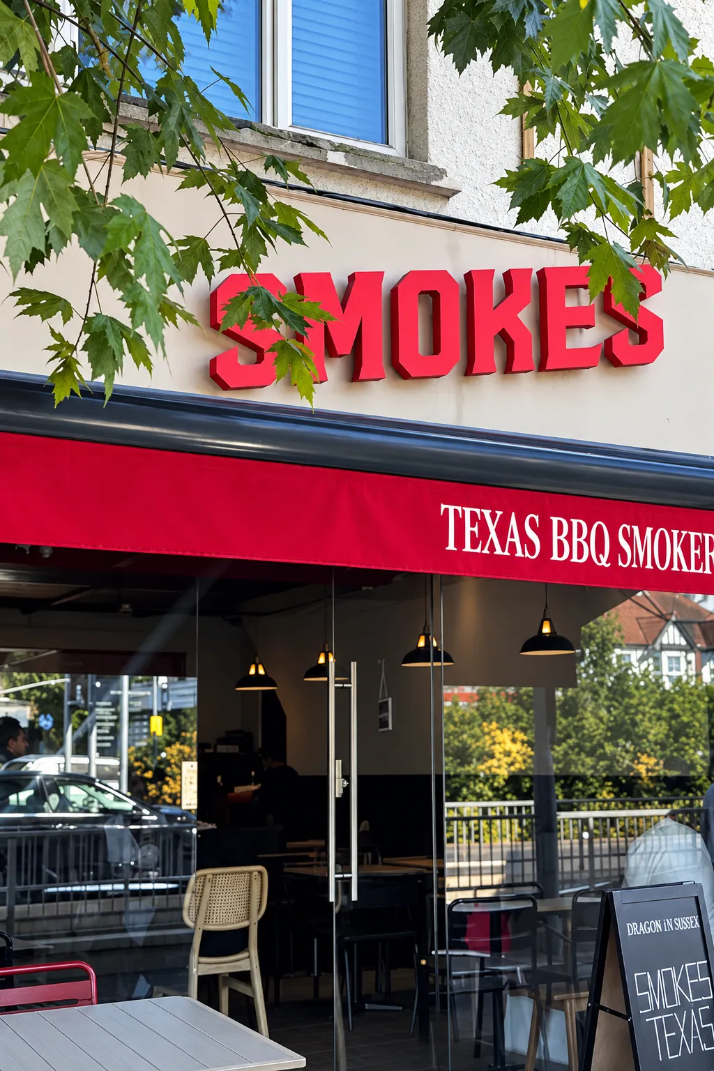 Smokes Texas BBQ Smokehouse shopfront with its red fascia and awning